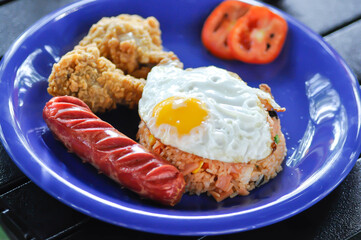 stir fried rice or fried rice with sunny side up egg , fried chicken and sausage