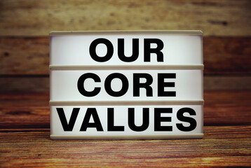 Lightbox with text "Our Core Values" on wooden background