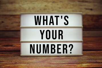 Lightbox with text "What's Your Number?" on wooden background