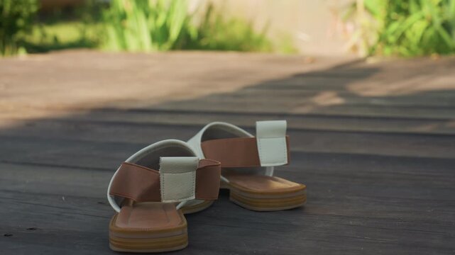 Fashion Sandals On Bright Sunlit Deck, Closeup Shot Of Stylish Sandals Against Soft Garden Background, Marketready Footwear Featuring Detailed Leather Straps And Warm Morning Sunlight Ambiance