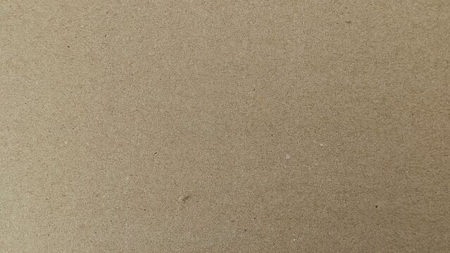Seamless light brown fiberboard texture background. Close-up of abstract compressed wood material surface and backdrop.