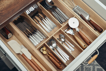 Bamboo organizer with cutlery in kitchen drawer