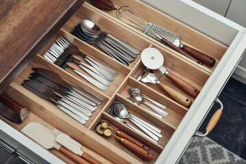 Bamboo organizer with cutlery in kitchen drawer