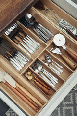 Bamboo organizer with cutlery in kitchen drawer