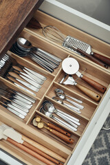 Bamboo organizer with cutlery in kitchen drawer