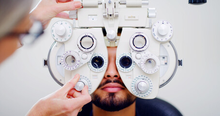 Optometrist, man or patient with eye exam machine, vision test or determine prescription for clear...
