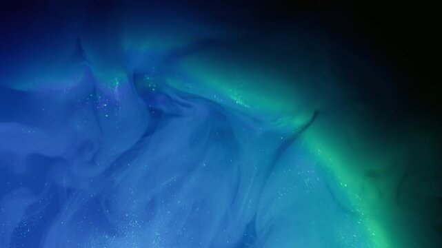 Ink mist. Rainbow cloud splash. Blur blue yellow color glitter water sparkling shimmer vapor spreading on abstract black art background.