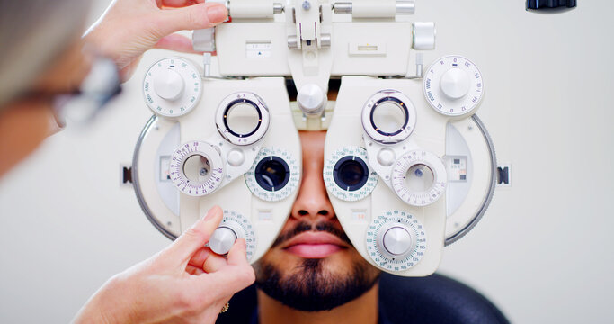 Optometrist, man or patient with eye exam machine, vision test or determine prescription for clear sight. Assessment, optometry or people with lens selection on phoropter, consultation or portrait