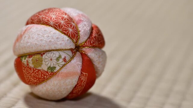Traditional Japanese Temari Ball Close Up on Tatami Mat Left