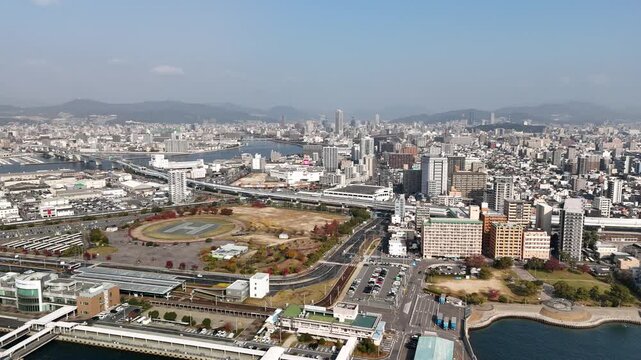 Hiroshima Port, Japan: 4K Aerial Drone Footage of Ferry Terminal, City Skyline, Hiroshima Bay, Harbour Infrastructure, Coastal Mountains and Waterfront Urban Landscape, Ujina Island and Kanawa Island
