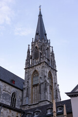 Fototapeta premium Aachen, North Rhine-Westphalia , Germany, August 23rd, 2025, Skyline marked by tall spire, Heritage monument standing tall amidst cityscape with weathered masonry and morning light