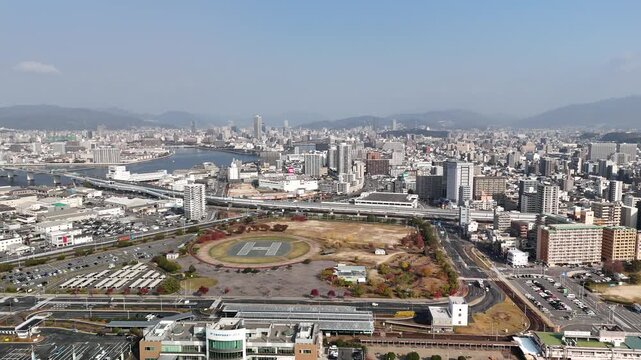 Hiroshima Port, Japan: 4K Aerial Drone Footage of Ferry Terminal, City Skyline, Hiroshima Bay, Harbour Infrastructure, Coastal Mountains and Waterfront Urban Landscape, Ujina Island and Kanawa Island