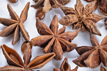 Minimalist star anise showcase with subtle shadows and textures, Sleek and simple presentation of star anise on plain white surface emphasizing textures and shadows