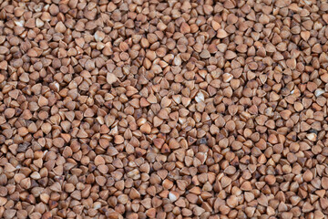 Neutraltoned buckwheat with rhythmic triangular shapes, Elegant design backdrop showcasing uniform buckwheat kernels in harmonious triangular arrangement with earthy coloring