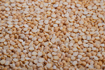 Soaking and cooking tips for comforting traditional pea dishes, Close examination of yellow split peas showcasing earthy texture and culinary uses for classic soups