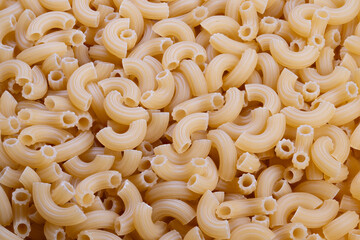Bulk pasta inventory, Extensive reserve of uncooked elbow macaroni for distribution needs, Vast storage of raw elbow macaroni indicating large supply chain capabilities