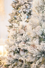 Blue Christmas tree with snowflakes falling on its branches