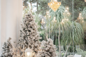 Blue Christmas tree with snowflakes falling on its branches