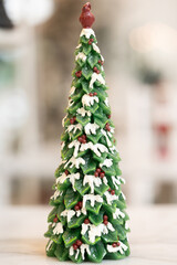 Blue Christmas tree with snowflakes falling on its branches