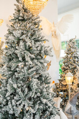 Blue Christmas tree with snowflakes falling on its branches