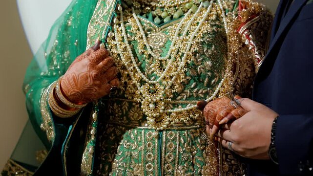 Bride and groom Mehndi holding each others hands during Wedding Photoshoot. Wedding henna painted hands