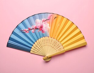 Asian-style fan with colorful gradients and floral design on pink
