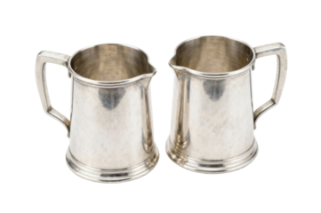 Two classic silver pitchers displayed elegantly on a dark backdrop