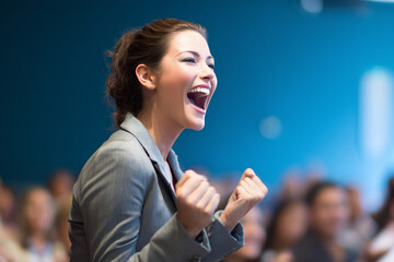  Exited woman motivational speaker on stage in front of an audience . Diversity, Success, Leadership