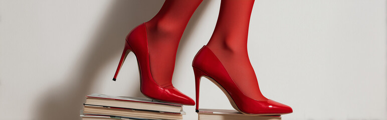 Female Legs in Red Heels on Books Studio Shot