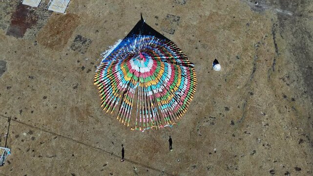 Qilian Grassland, Xining, Qinghai Province, China - A Top-down View of a Colorful Circular Structure Standing Alone on a Vast Grassland - Orbit Drone Shot