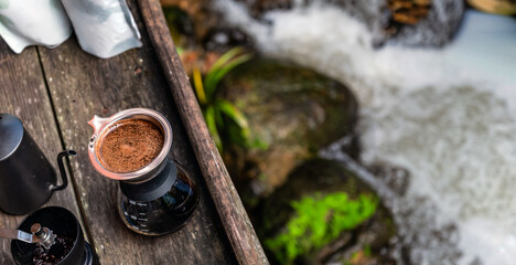 drip coffee set on the wood terrace at the coffee shop next to freshness small river stream