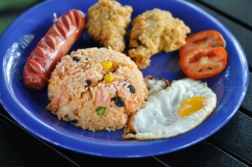stir fried rice or fried rice with sunny side up egg , fried chicken and sausage