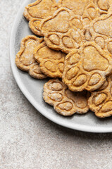 Homemade paw print dog treats on a plate
