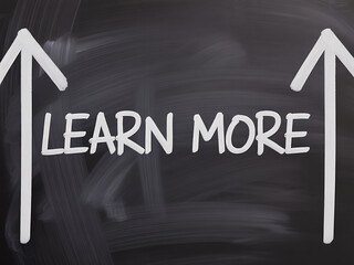 Learn more concept depicted on a chalkboard with two upward arrows