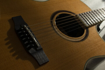 This is a close-up of the strings of an acoustic guitar.