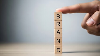 Building a strong brand identity concept with wooden letter blocks and a hand