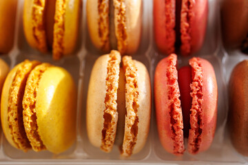 Macro detail of colorful macarons texture in plastic tray