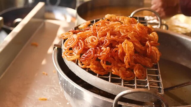 Jalebi being deep fried at a sweet shop in morning
