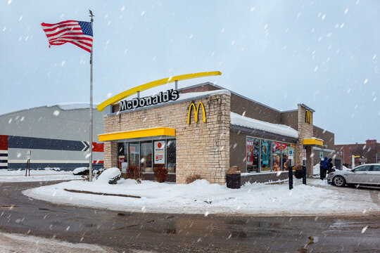 Utica, NY - Dec 9, 2025: A winter snowfall view of McDonald's Restaurant as a concept of warmth and food entertainment from cold weather, this site is located at 1700 Genesee St, Utica, NY 13501