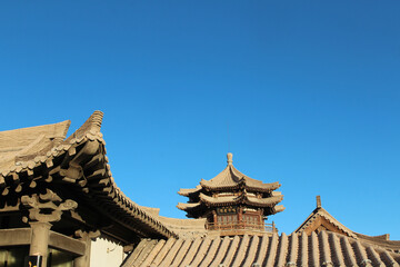 Mingyue pavilion with a plaque that reads: “Mingshan Shan - Ming Bu Xu Chuan” as meaning Singing Sand Dunes (Mingsha Shan) as deserve the reputation one enjoys, Dunhuang in Gansu Province of China