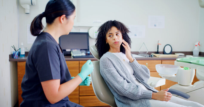 Appointment, consulting and toothache with woman at dentist for mouth surgery or oral care. Cavity, gum disease or tooth decay with dental professional and patient in office for checkup