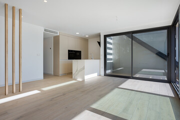 Bright open kitchen and living area with wooden accents