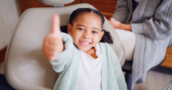Portrait, smile and thumbs up with girl at dentist for optometry goals, success or support. Emoji, hand gesture and motivation with child in chair at dental clinic for healthcare or wellness