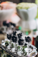 Fresh blueberries in elegant glasses on silver tray