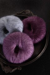 Warm fluffy yarn for knitting. Natural mohair. Multi-colored wool yarn for handmade.Dark background.