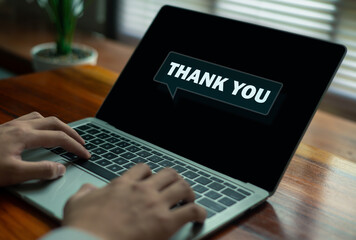 Businessman holding Laptop virtual thank you text, symbolizing appreciation, communication, gratitude, and professional connection in modern business and digital interaction concept.