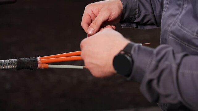 Inspecting Cable Splice, Technician Carefully Encasing Connection With Protective Adhesive Layer