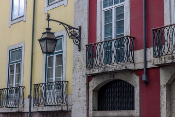 Colourful facades and wrought-iron lanterns in the old town of Lisbon, Portugal.
