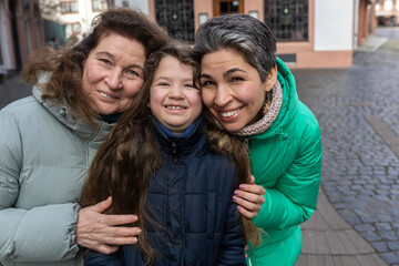 A family walk through an old European city. Three generations of women
