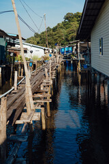 Fototapeta premium Narrow Wooden Walkway over Water in Ban Ao Yai, Koh Kood, Thailand